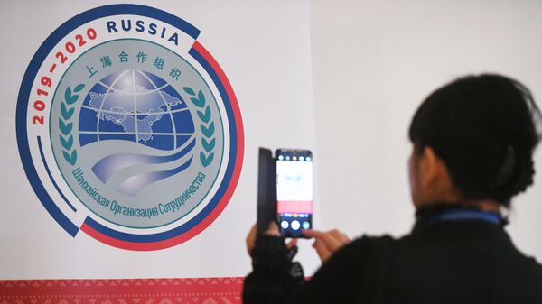 Участница совещания руководителей министерств и ведомств науки и техники государств-членов ШОС фотографирует логотип председательства России в ШОС Участница совещания руководителей министерств и ведомств науки и техники государств-членов ШОС фотографирует логотип председательства России в ШОС