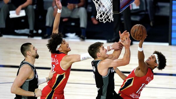 LAKE BUENA VISTA, FLORIDA - AUGUST 06: Bogdan Bogdanovic #8 of the Sacramento Kings, center right, competes for an offensive rebound against New Orleans Pelicans' Frank Jackson #15, right, and Pelicans' Jaxson Hayes #10, center left, as Kings' Alex Len #25, left, looks on during the second half of an NBA basketball game at HP Field House at ESPN Wide World Of Sports Complex on August 6, 2020 in Lake Buena Vista, Florida. NOTE TO USER: User expressly acknowledges and agrees that, by downloading and or using this photograph, User is consenting to the terms and conditions of the Getty Images License Agreement. Ashley Landis-Pool/Getty Images/AFP LAKE BUENA VISTA, FLORIDA - AUGUST 06: Bogdan Bogdanovic #8 of the Sacramento Kings, center right, competes for an offensive rebound against New Orleans Pelicans' Frank Jackson #15, right, and Pelicans' Jaxson Hayes #10, center left, as Kings' Alex Len #25, left, looks on during the second half of an NBA basketball game at HP Field House at ESPN Wide World Of Sports Complex on August 6, 2020 in Lake Buena Vista, Florida. NOTE TO USER: User expressly acknowledges and agrees that, by downloading and or using this photograph, User is consenting to the terms and conditions of the Getty Images License Agreement. Ashley Landis-Pool/Getty Images/AFP