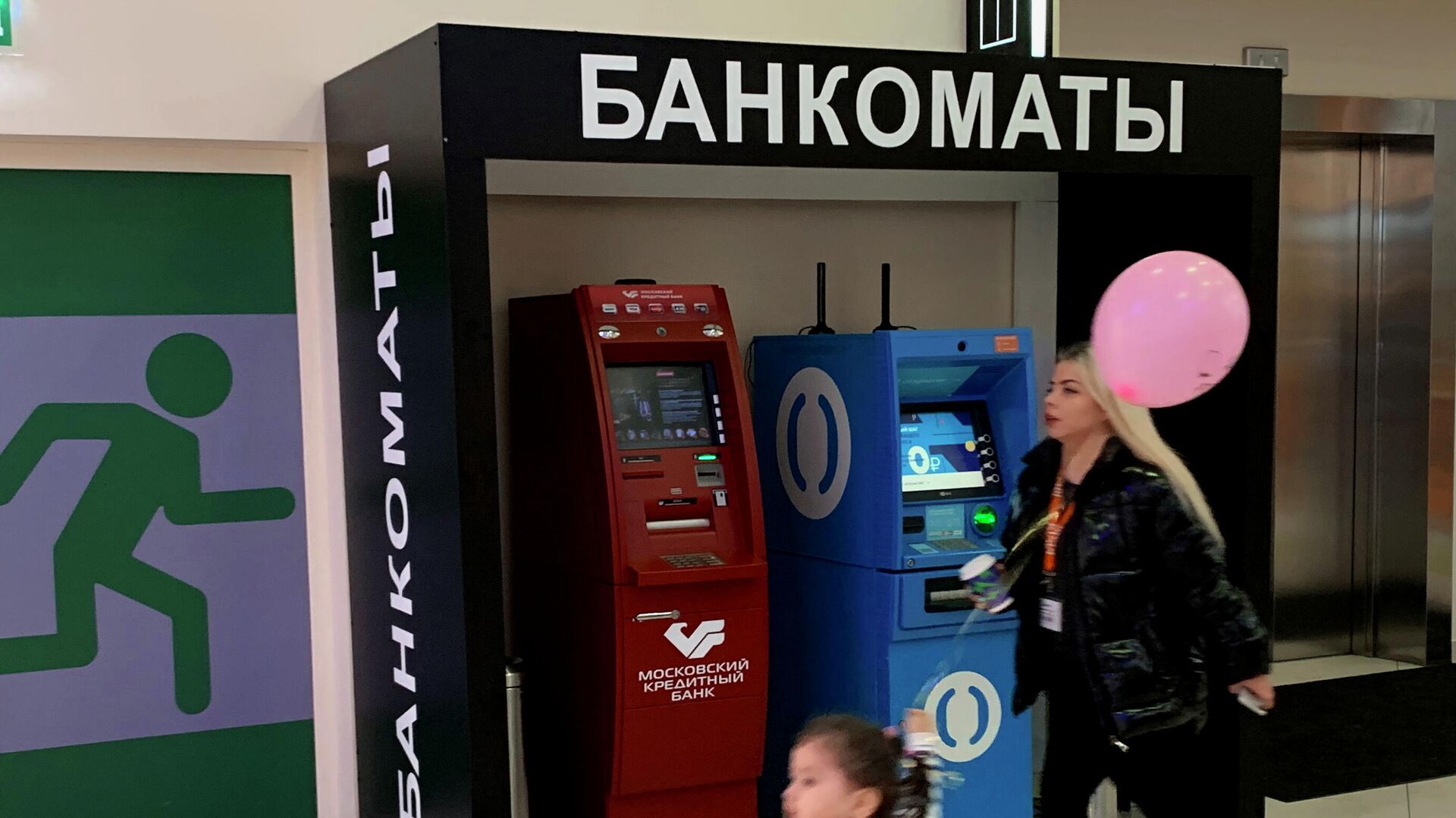 Женщина с ребенком проходят мимо банкоматов Женщина с ребенком проходят мимо банкоматов - РИА Новости, 1920, 20.10.2020