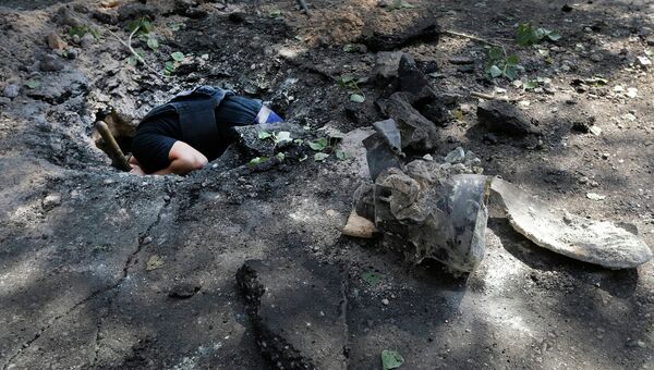 Воронка на месте падения снаряда в Донецке, архивное фото Воронка на месте падения снаряда в Донецке, архивное фото