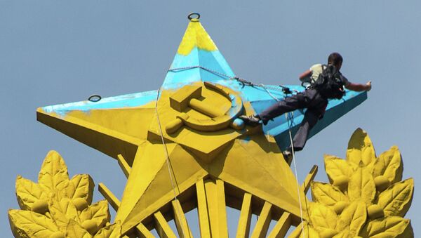 Рабочий закрашивает звезду на шпиле высотного здания на Котельнической набережной в Москве. Архивное фото Рабочий закрашивает звезду на шпиле высотного здания на Котельнической набережной в Москве. Архивное фото