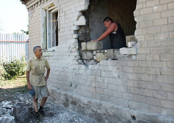 Мужчина ремонтирует стену жилого дома в Горловке после обстрела Мужчина ремонтирует стену жилого дома в Горловке после обстрела