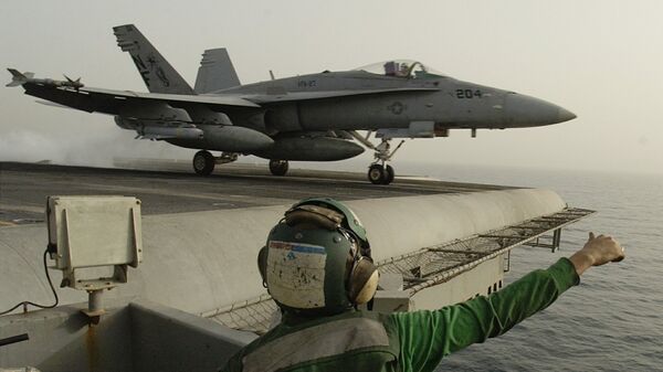 Американский штурмовик F/A-18 Hornet взлетает с палубы авианосца Китти Хоук в Персидском заливе. 21 марта 2003