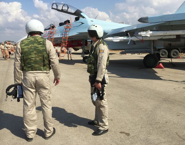 Российские летчики готовятся к посадке в истребитель Су-30 перед вылетом с аэродрома Хмеймим в Сирии Российские летчики готовятся к посадке в истребитель Су-30 перед вылетом с аэродрома Хмеймим в Сирии