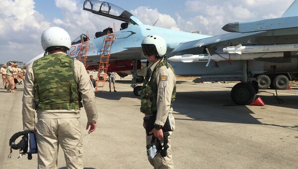 Российские летчики готовятся к посадке в истребитель Су-30 перед вылетом с аэродрома Хмеймим в Сирии Российские летчики готовятся к посадке в истребитель Су-30 перед вылетом с аэродрома Хмеймим в Сирии