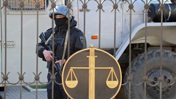 Сотрудник правоохранительных органов у здания Донецкого городского суда Ростовской области, где проходит слушание по делу украинской летчицы Надежды Савченко, Архивное фото Сотрудник правоохранительных органов у здания Донецкого городского суда Ростовской области, где проходит слушание по делу украинской летчицы Надежды Савченко, Архивное фото