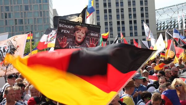 Участники акции протеста в Берлине против политики Ангелы Меркель Участники акции протеста в Берлине против политики Ангелы Меркель
