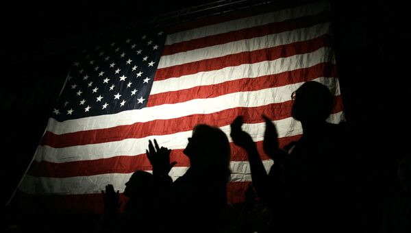 Люди на фоне американского флага. Архивное фото Люди на фоне американского флага. Архивное фото