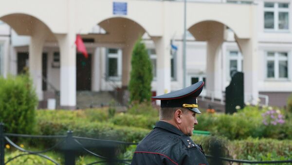 Сотрудник правоохранительных органов у здания школы, где подросток открыл стрельбу. Архивное фото Сотрудник правоохранительных органов у здания школы, где подросток открыл стрельбу. Архивное фото