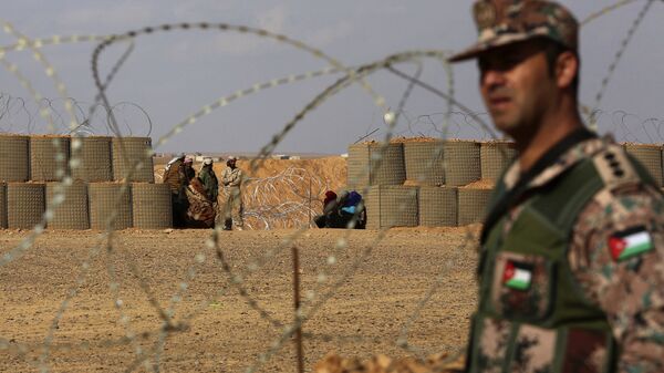 Иорданский военнослужащий возле лагеря беженцев Эр-Рукбан на сирийско-иорданской границе