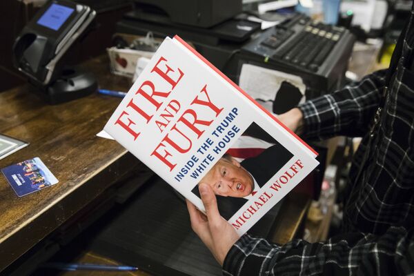 Продавец с книгой Огонь и ярость: внутри Белого дома Трампа в магазине Barnes & Noble в Филадельфии, США. 5 января 2018 Продавец с книгой Огонь и ярость: внутри Белого дома Трампа в магазине Barnes & Noble в Филадельфии, США. 5 января 2018