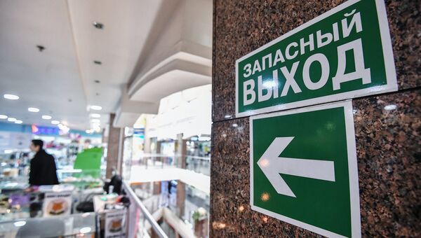 Указатель и знак Запасный выход в торговом центре Указатель и знак Запасный выход в торговом центре