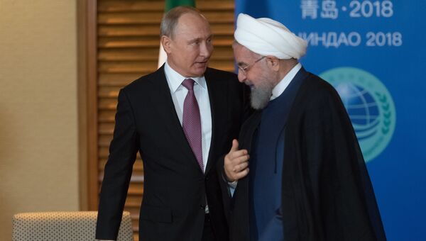Владимир Путин и президент Ирана Хасан Роухани во время встречи на полях саммита ШОС. 9 июня 2018 Владимир Путин и президент Ирана Хасан Роухани во время встречи на полях саммита ШОС. 9 июня 2018