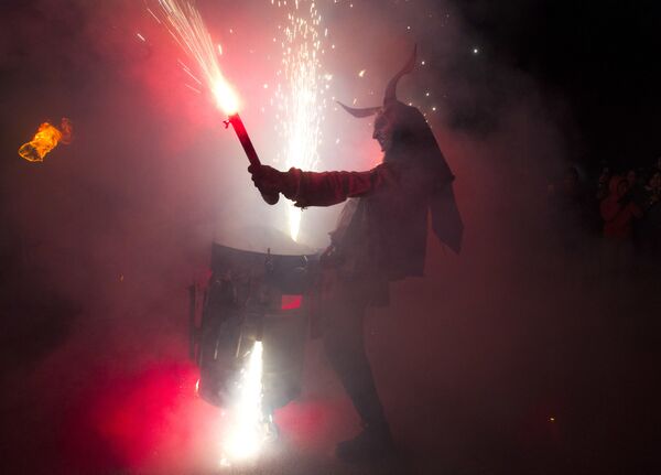 Участник фестиваля Correfoc в костюме демона в Пальма-де-Мальорке, Испания Участник фестиваля Correfoc в костюме демона в Пальма-де-Мальорке, Испания