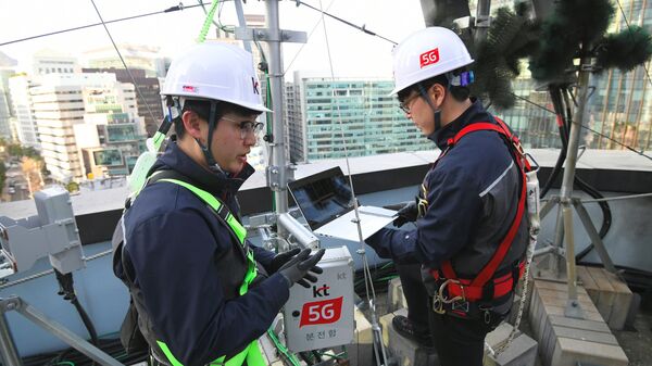 Технические специалисты южнокорейского оператора связи KT Corp. настраивают оборудование для использования мобильной сети 5G на крыше здания в Сеуле. 4 апреля 2019