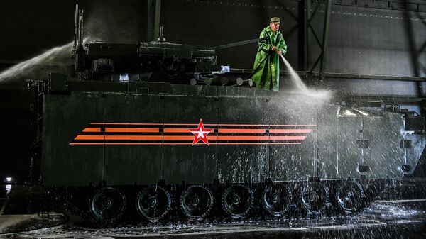 Военнослужащий моет боевую машину пехоты на гусеничной платформе Курганец-25