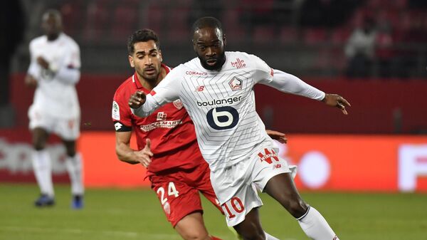 Lille's French forward Jonathan Ikone (R) vies with Dijon's French defender Wesley Lautoa (L) during the French L1 football match between Dijon Football Cote-D'Or and Lille LOSC at the Gaston Gerard stadium in Dijon, central France on January 12, 2020. (Photo by PHILIPPE DESMAZES / AFP)