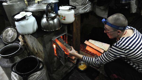 Послушница топит печь в буддийском монастыре Шад Тчуп Линг, на горе Качканар в Свердловской области. Архивное фото Послушница топит печь в буддийском монастыре Шад Тчуп Линг, на горе Качканар в Свердловской области. Архивное фото